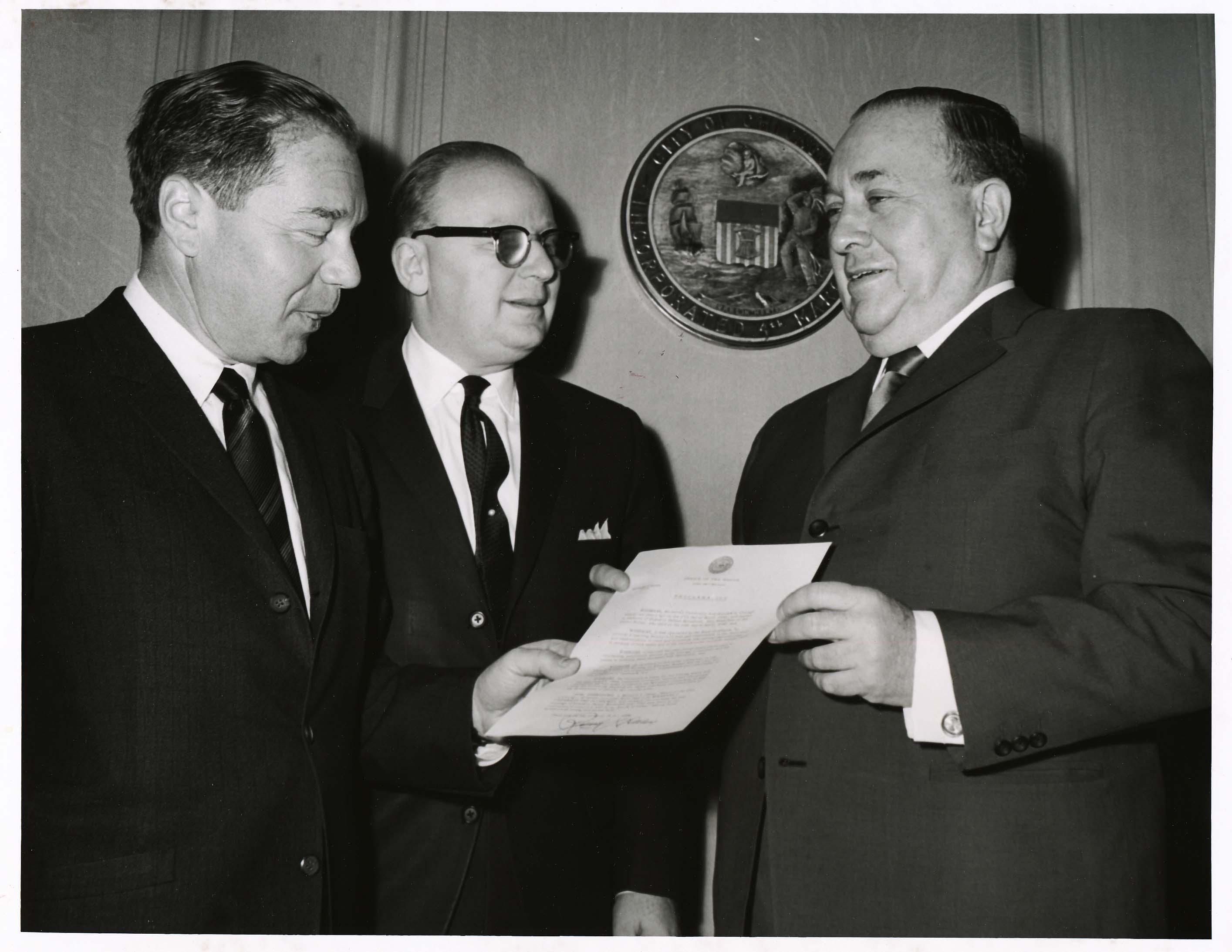 Left to right: Jerome Stone, Rolf Weil, and Mayor Richard J. Daley with a proclamation proclaiming Roosevelt University Day, April 1966.  Photo by Chicago Photographers.
